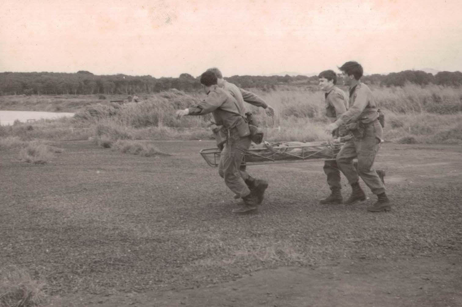 Members of 1 FD SQN GP practicing medical evacuation.  Rowes Lagoon in background – 1971.